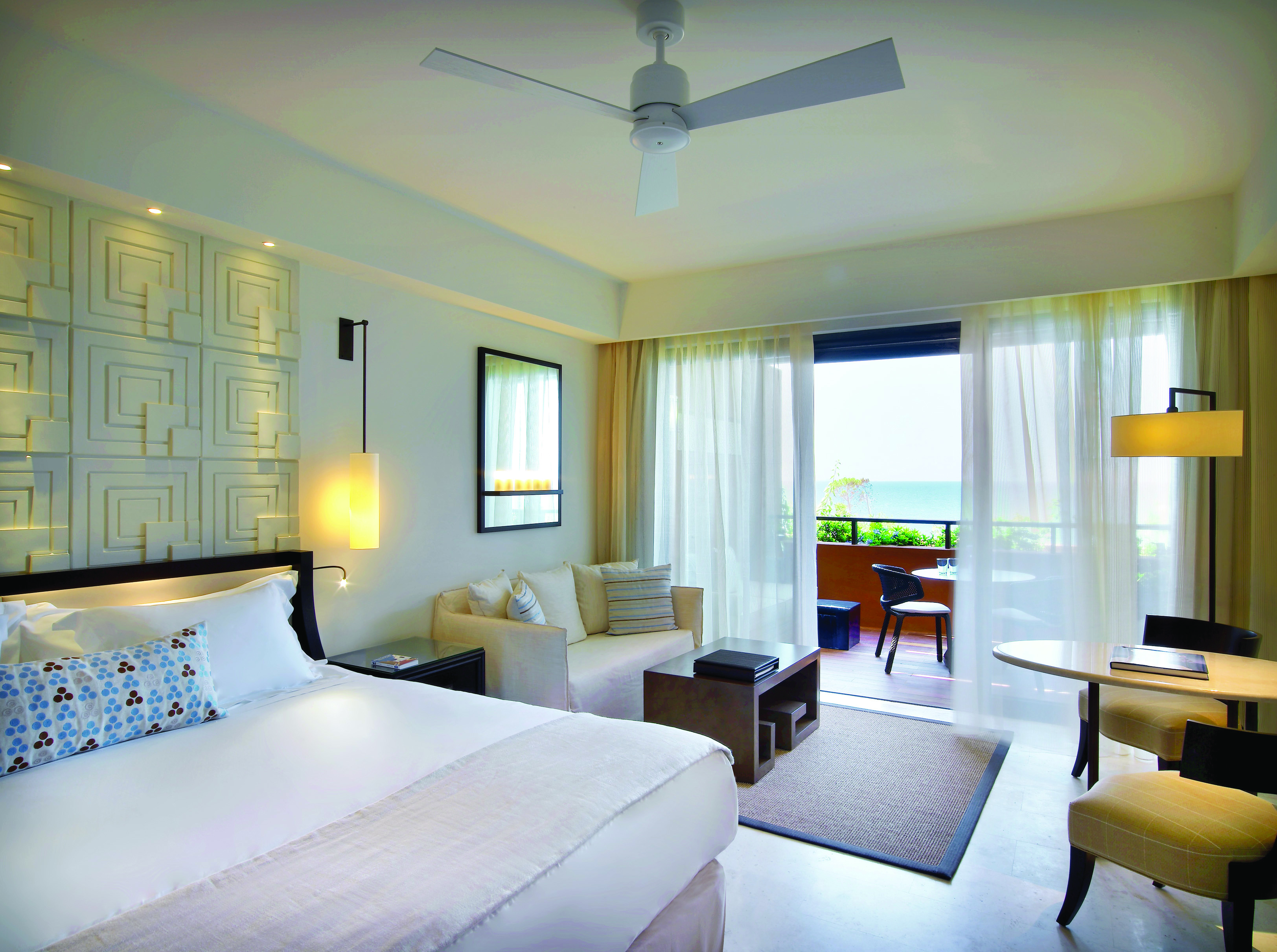 The Romanos Greece balcony bedroom with sofa and sea view