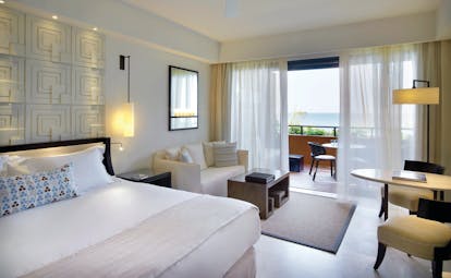 The Romanos Greece balcony bedroom with sofa and sea view
