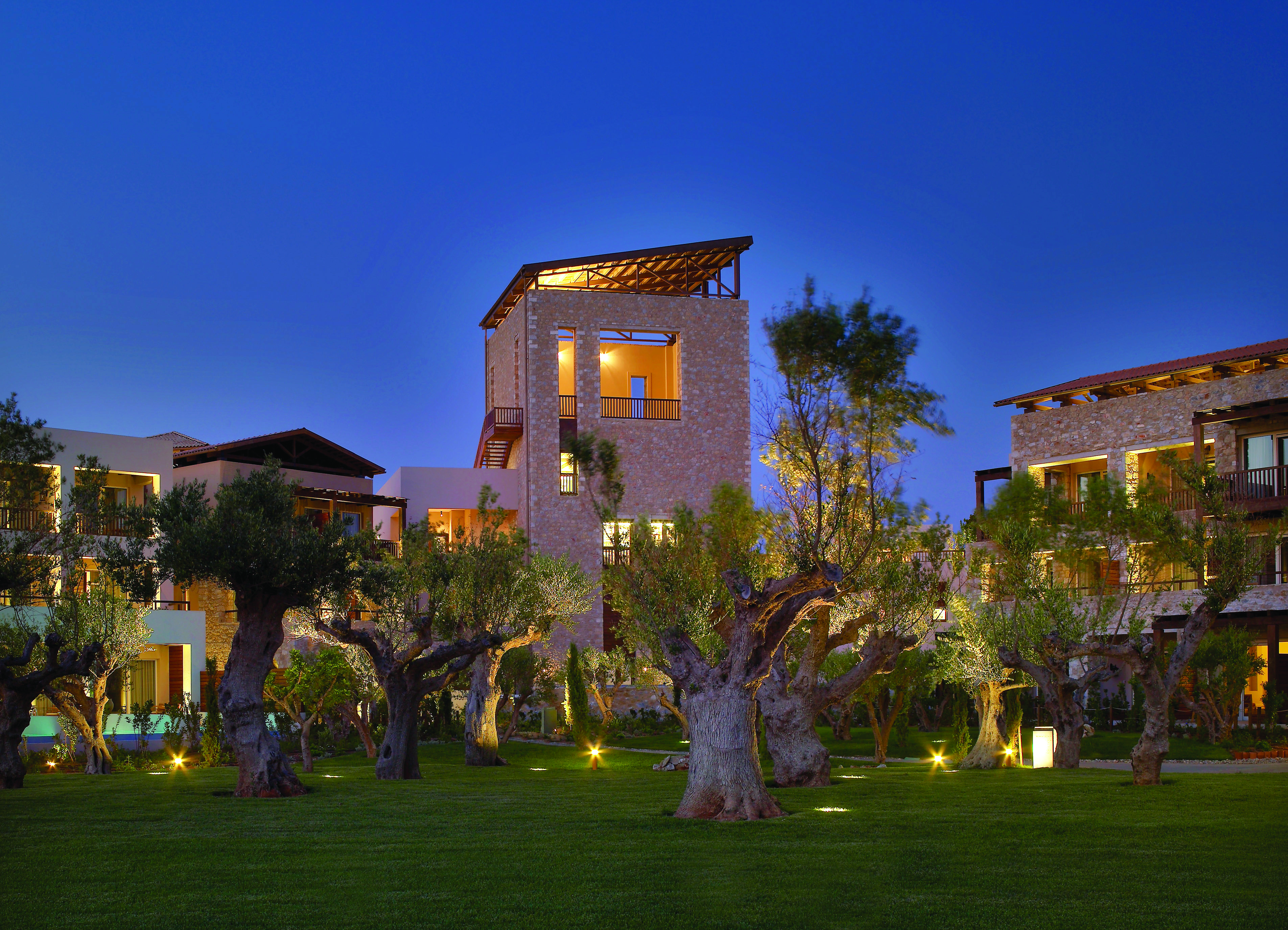 View of the Westin Resort from the outside at dusk, showing it dimly lit and surrounded by palm trees