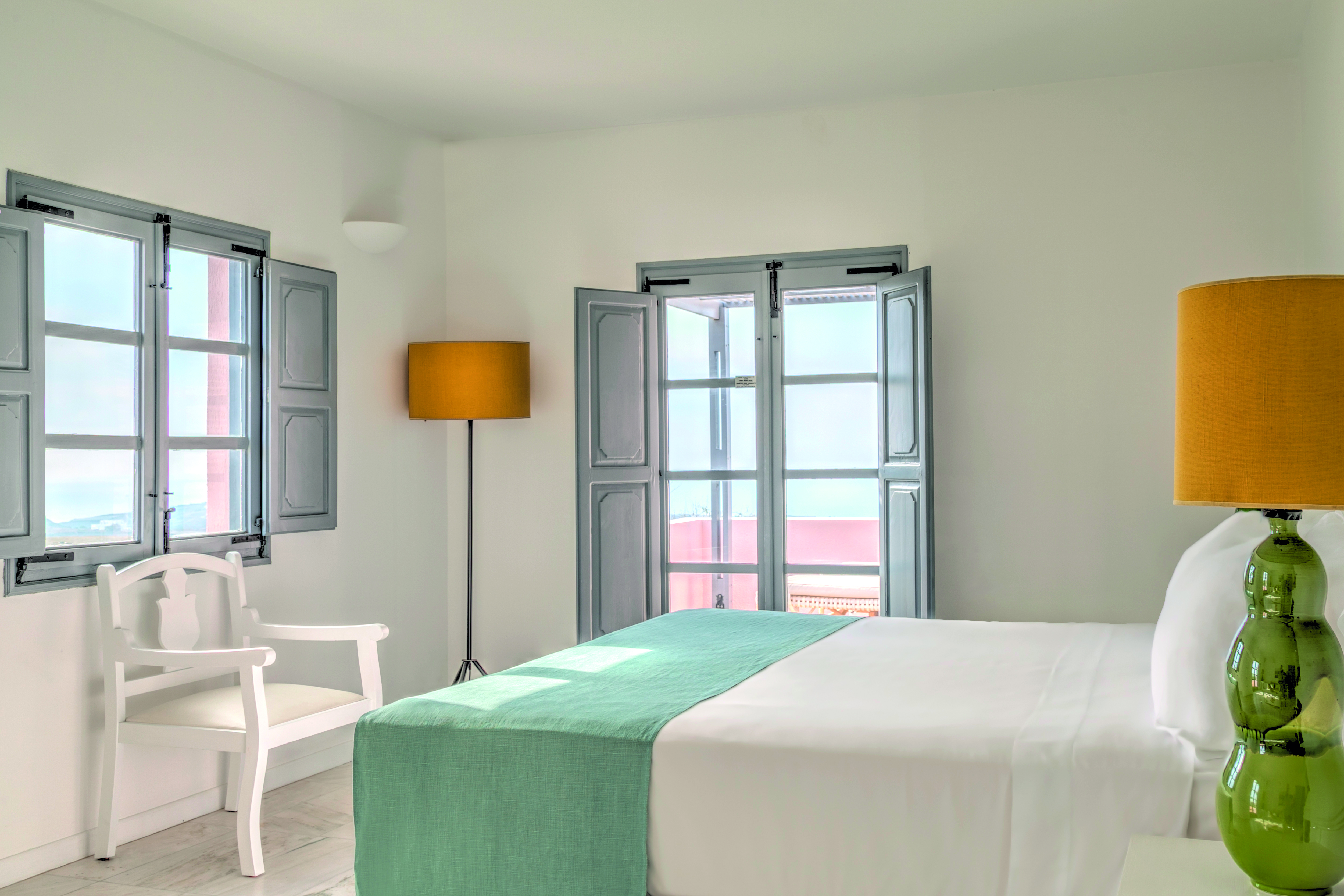 Vedema Resort Greece Dorian suite bedroom with window and grey shutters and patio doors