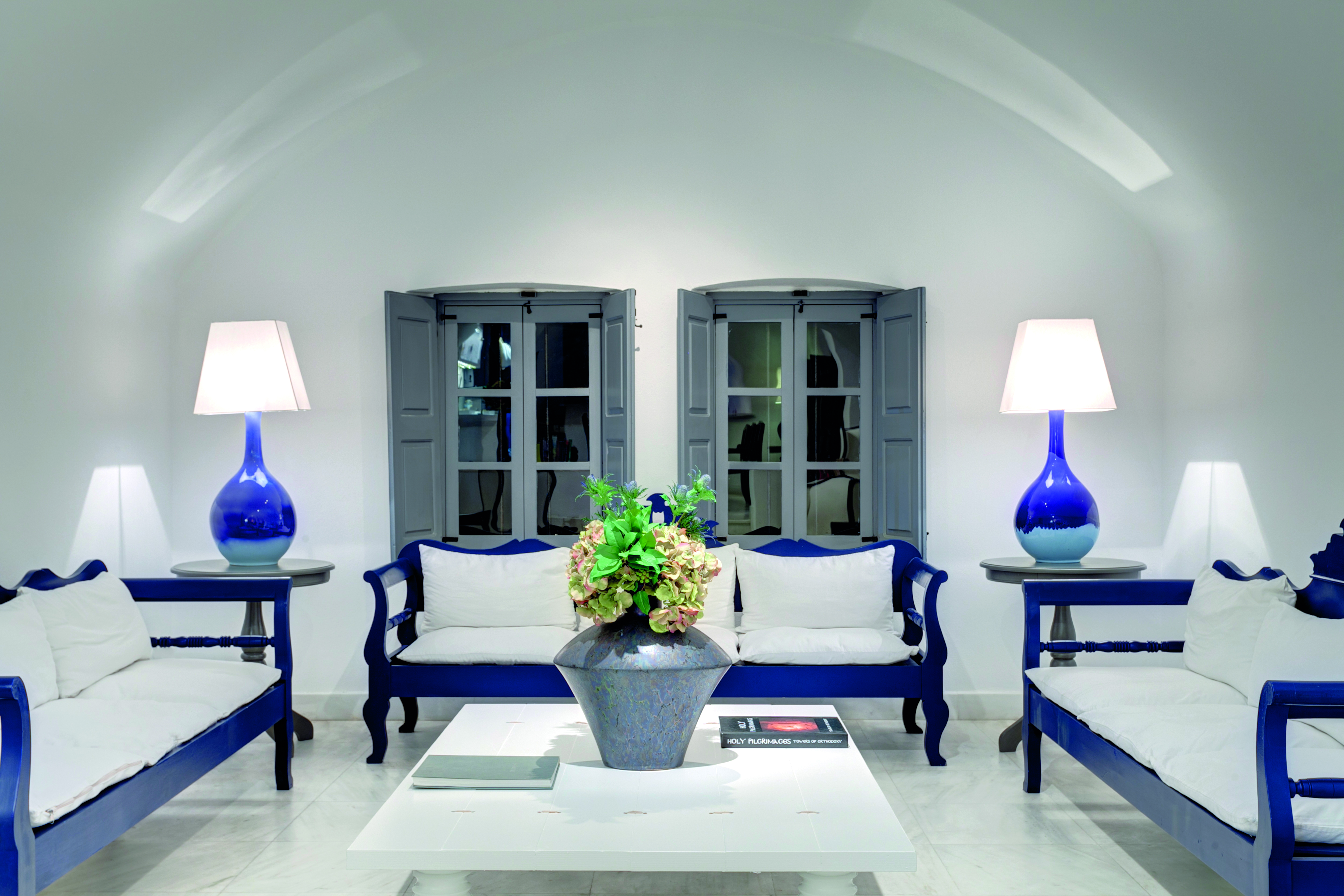Vedema Resort Greece lobby area with grey shutters and blue benches