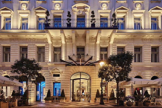 Aria Hotel Budapest exterior facade large cream stone building with a balcony and a ground floor terrace area