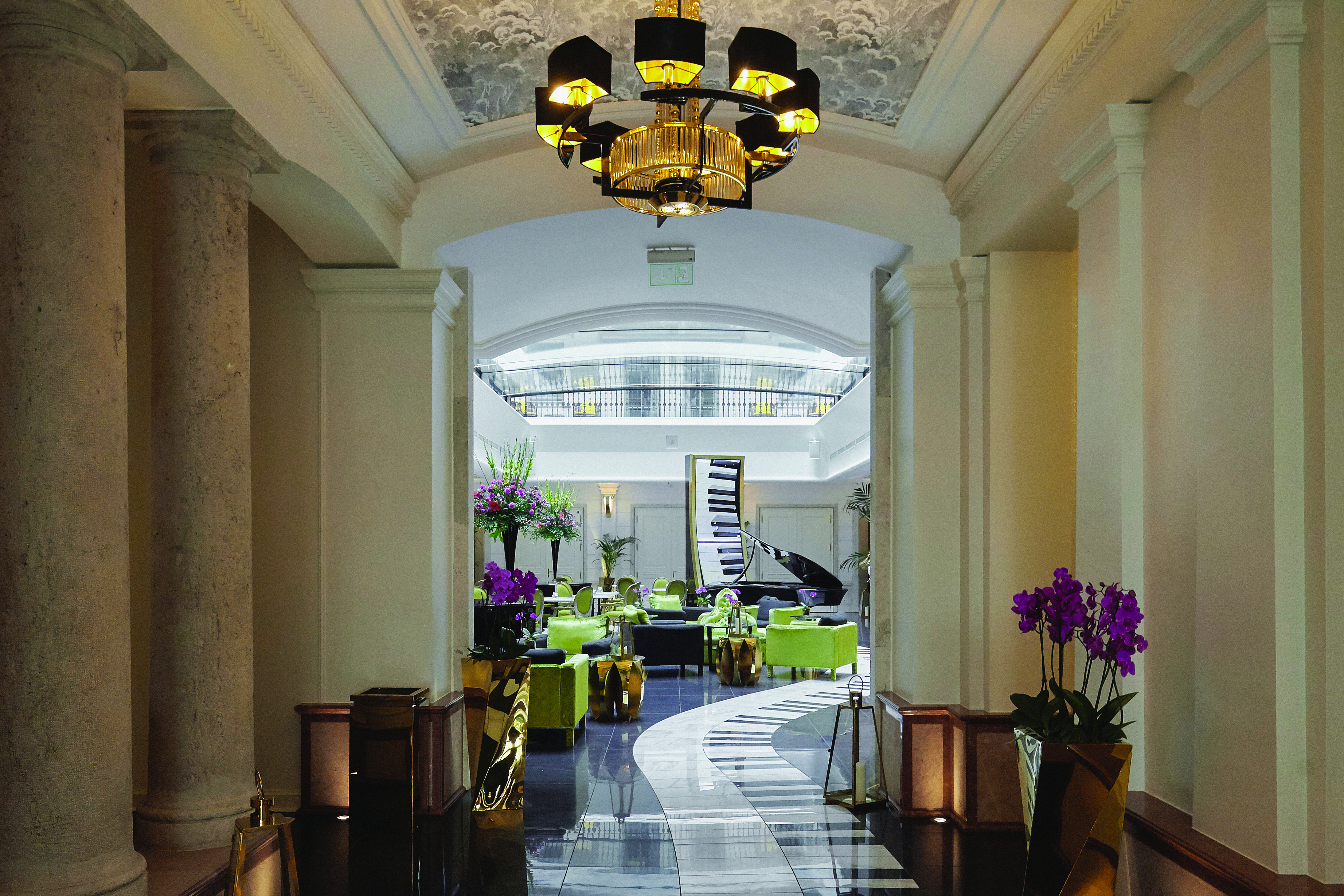 Aria Hotel Budapest piano bar lobby lounge with grand piano armchairs and piano key tiled floor