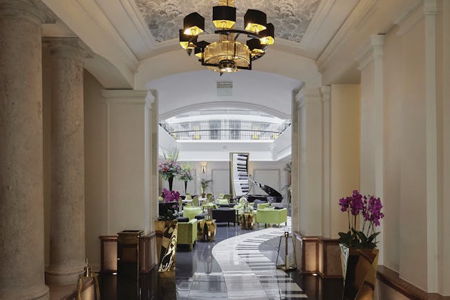 Aria Hotel Budapest piano bar lobby lounge with grand piano armchairs and piano key tiled floor