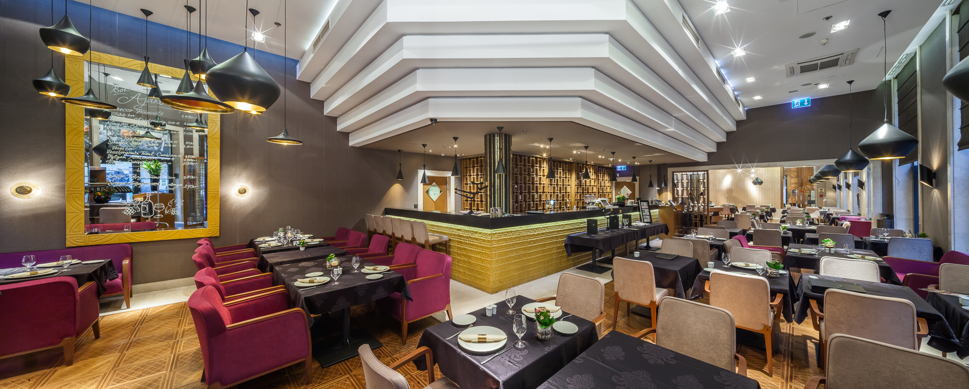 Continental Hotel restaurant, grand modern decor, velvet chair, black tables