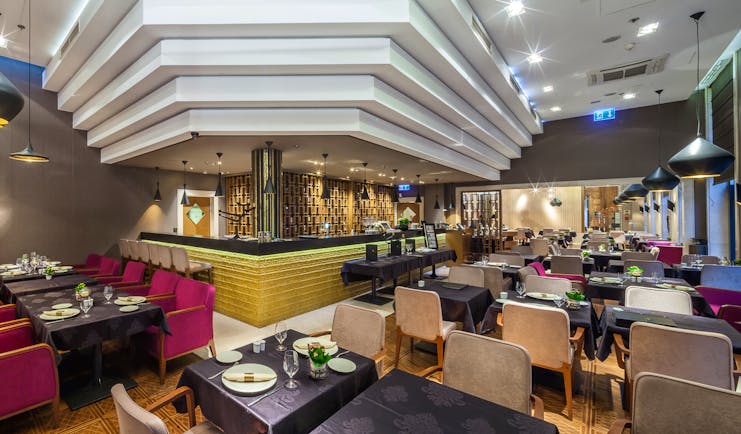 Continental Hotel restaurant, grand modern decor, velvet chair, black tables
