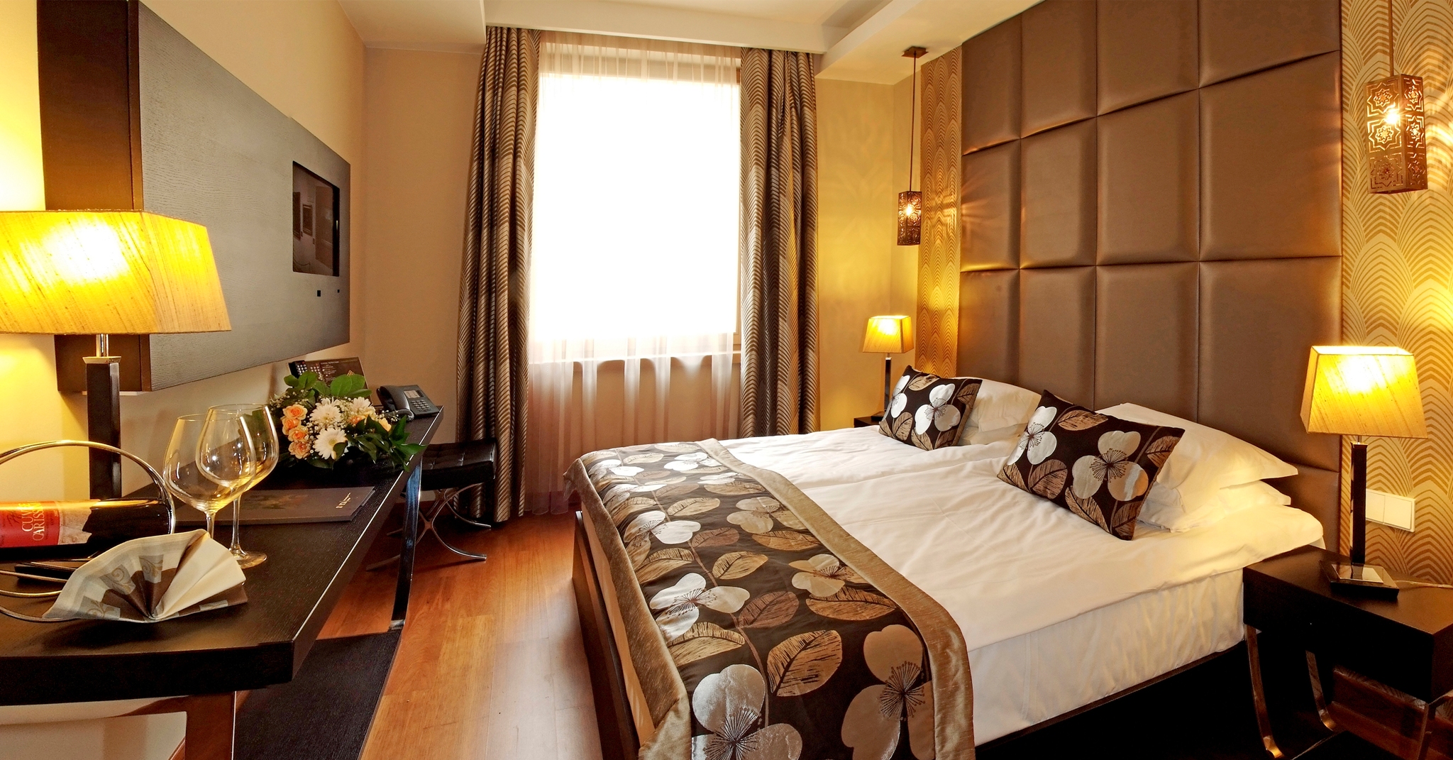 Continental Hotel standard room, double bed, desk, warm modern interiors