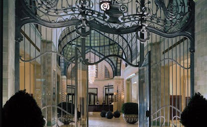 Four Seasons Gresham Palace Hungary atrium wrought iron gate glass roof chandelier