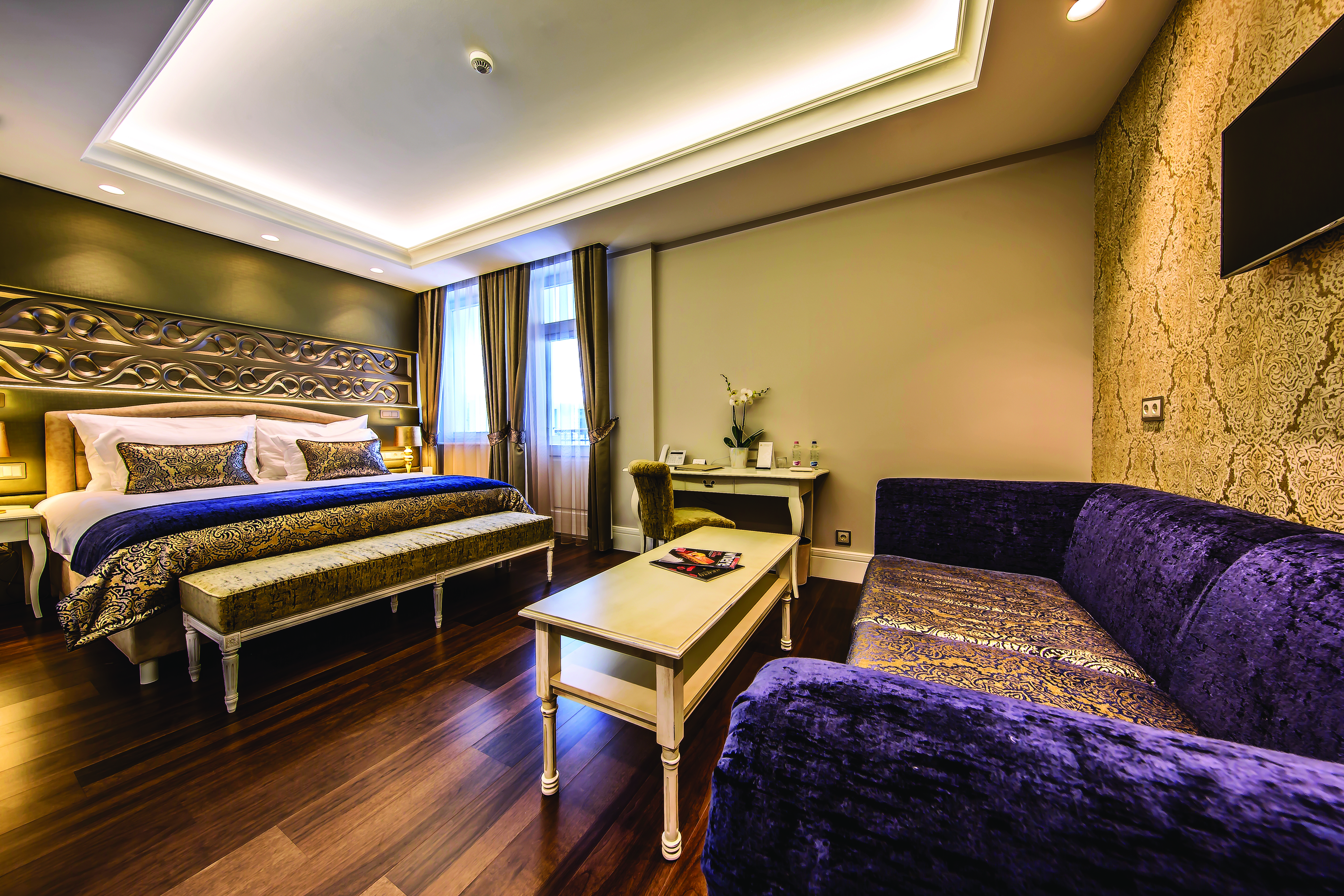 Prestige Hotel Budapest deluxe executive bedroom carved head board sofa coffee table desk and chairs