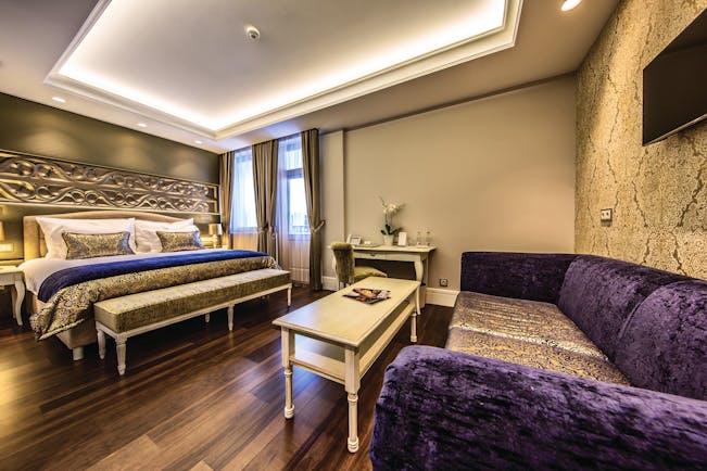 Prestige Hotel Budapest deluxe executive bedroom carved head board sofa coffee table desk and chairs