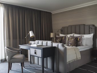 Britannia Hotel deluxe room with beige and grey and table