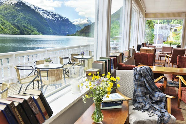 Fjaerland Fjordstove Hotell terrace with dining overlooking lake