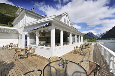 Fjaerland Fjordstove Hotell wooden decking and verandah overlooking lake