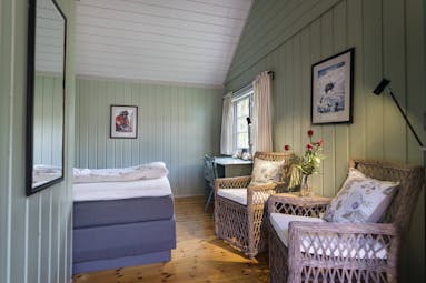 Single room with green painted wooden walls