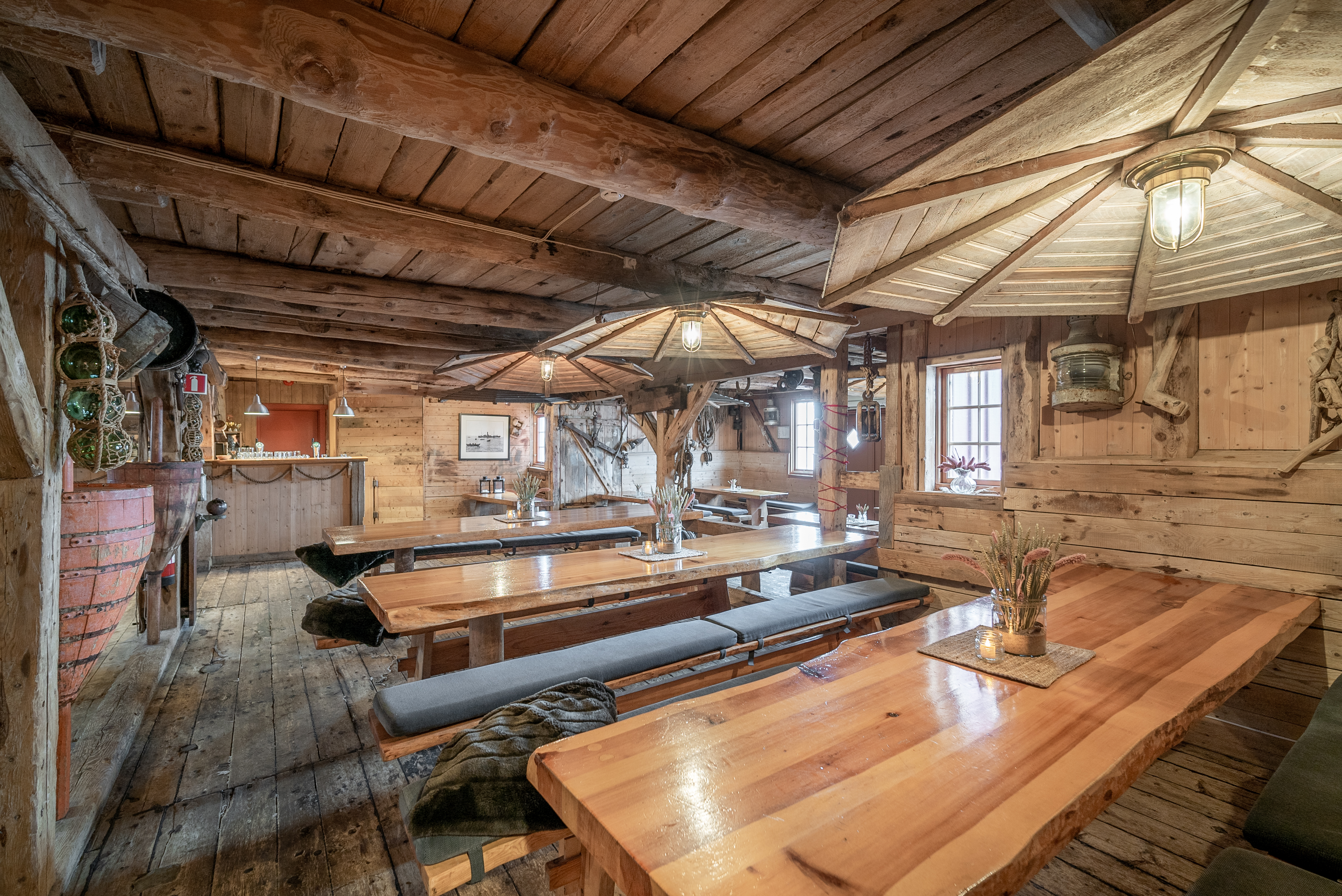 Inside of wooden cabin with long wooden dining tables