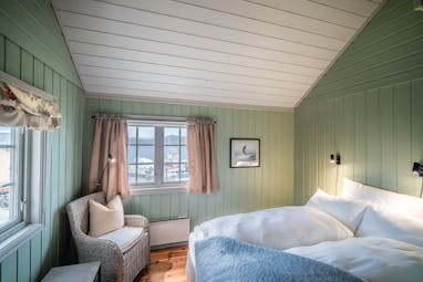 Green and white and blue room with wood