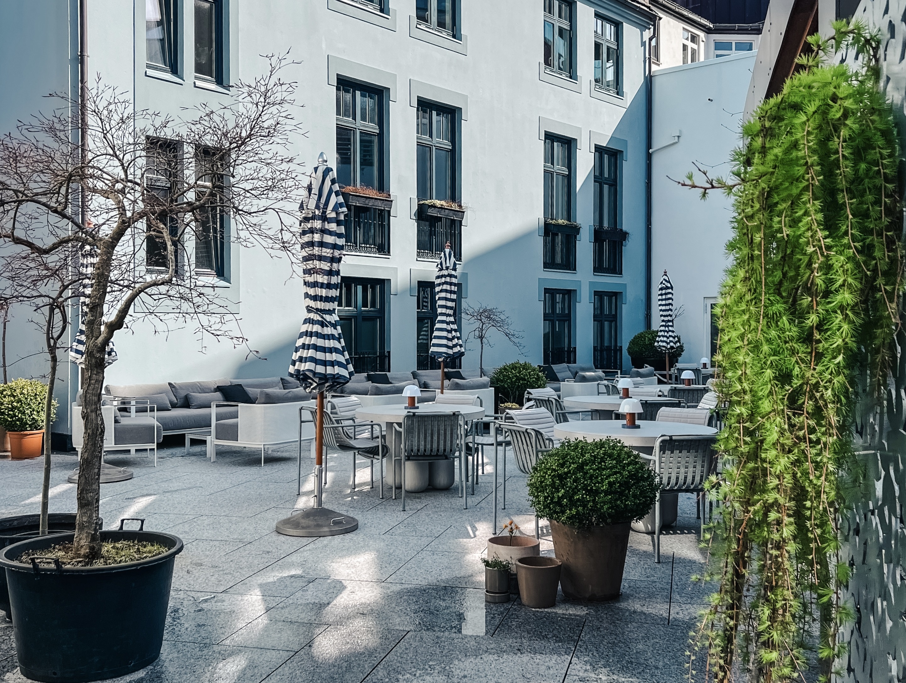 Hotel 1904 restaurant courtyard with the white hotel building in the background