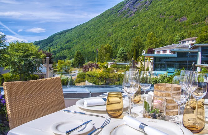 Hotel Alexandra Loen table set for dinner outside with water views