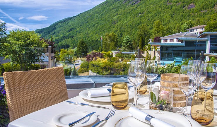 Hotel Alexandra Loen table set for dinner outside with water views