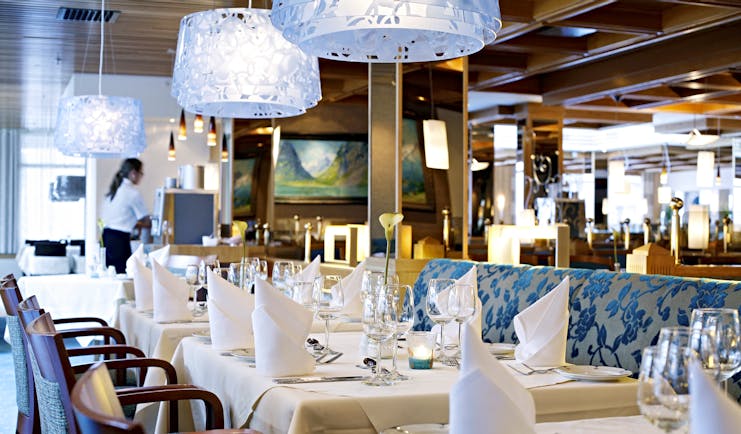 Hotel Alexandra Loen blue chairs of restaurant with large glass lights