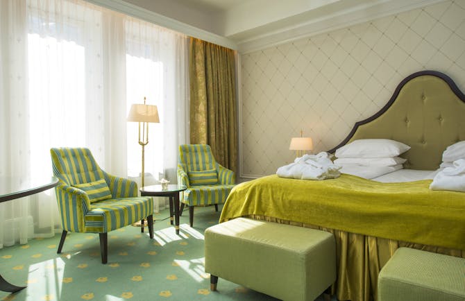 Standard room at Hotel Bristol Oslo with yellow and green soft furnishings