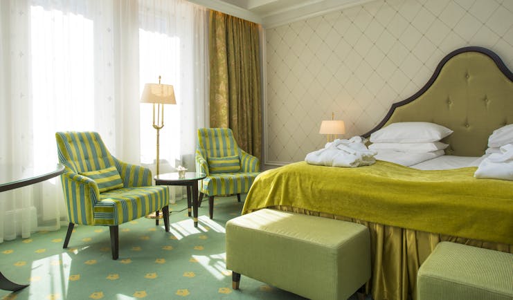 Standard room at Hotel Bristol Oslo with yellow and green soft furnishings