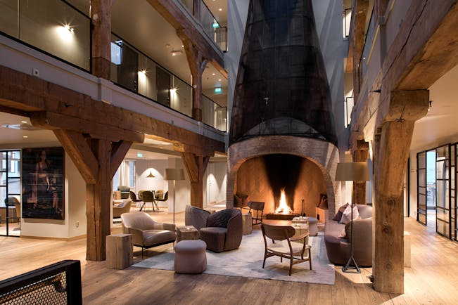 Hotel Brosundet Alesund lobby with large fireplace and galleries above