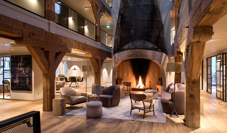 Hotel Brosundet Alesund lobby with large fireplace and galleries above