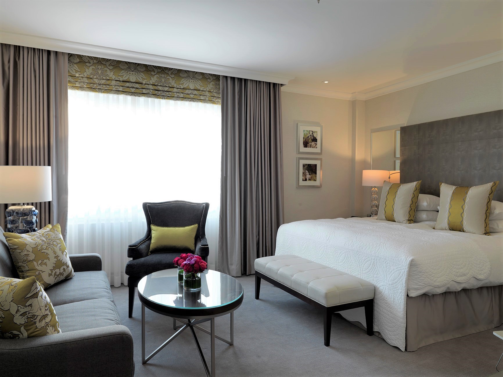 Hotel Continental Oslo white and grey bedroom with yellow cushions and sofa