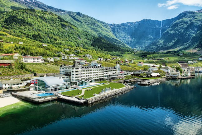 Hotel Ullensvang Norway view of large hotel on side of water with grass and mountains