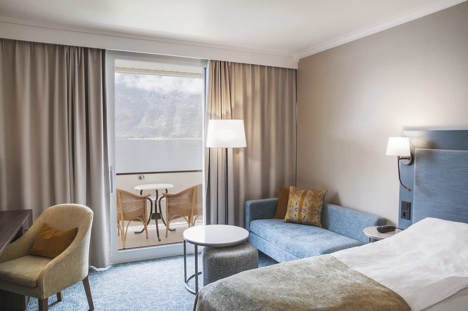Hotel Ullensvang Norway standard room with beige and blue and balcony