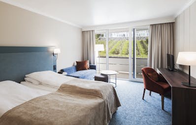 Hotel Ullensvang Norway blue and beige bedroom with balcony and view