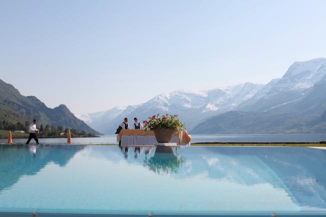 Hotel Ullensvang Norway view of pool, fjord waters and mountains