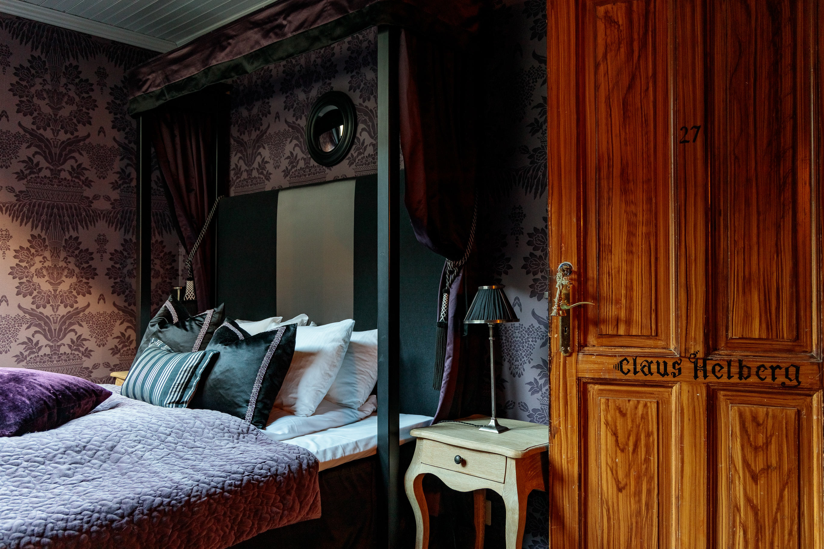 hotel union oye norway b edroom with patterned walls and wooden door