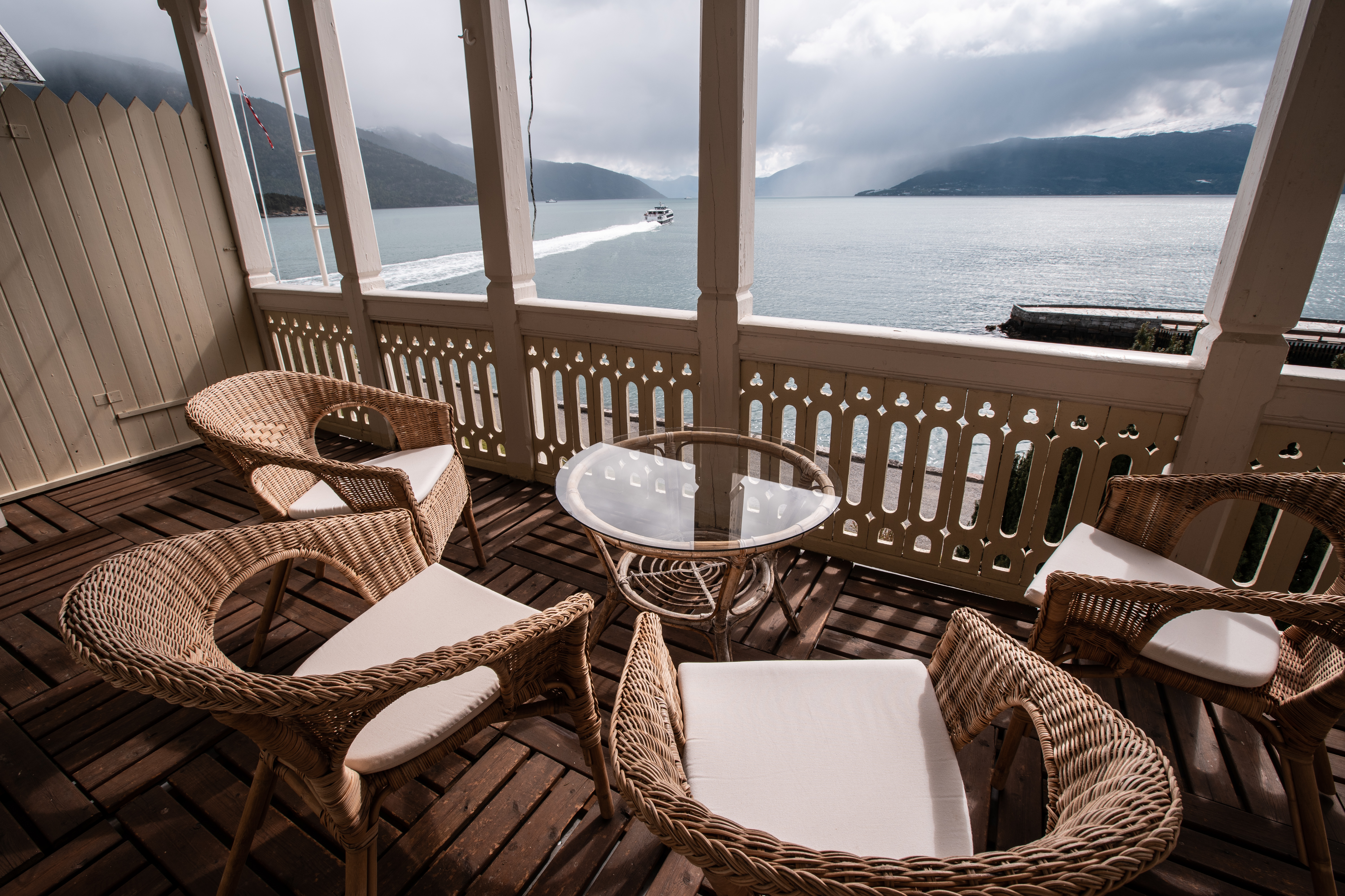 Four wicker seats on balcony overlooking fjord at Kviknes Hotel