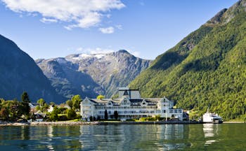 Exterior of white hotel building on fjord side at Kviknes hotel