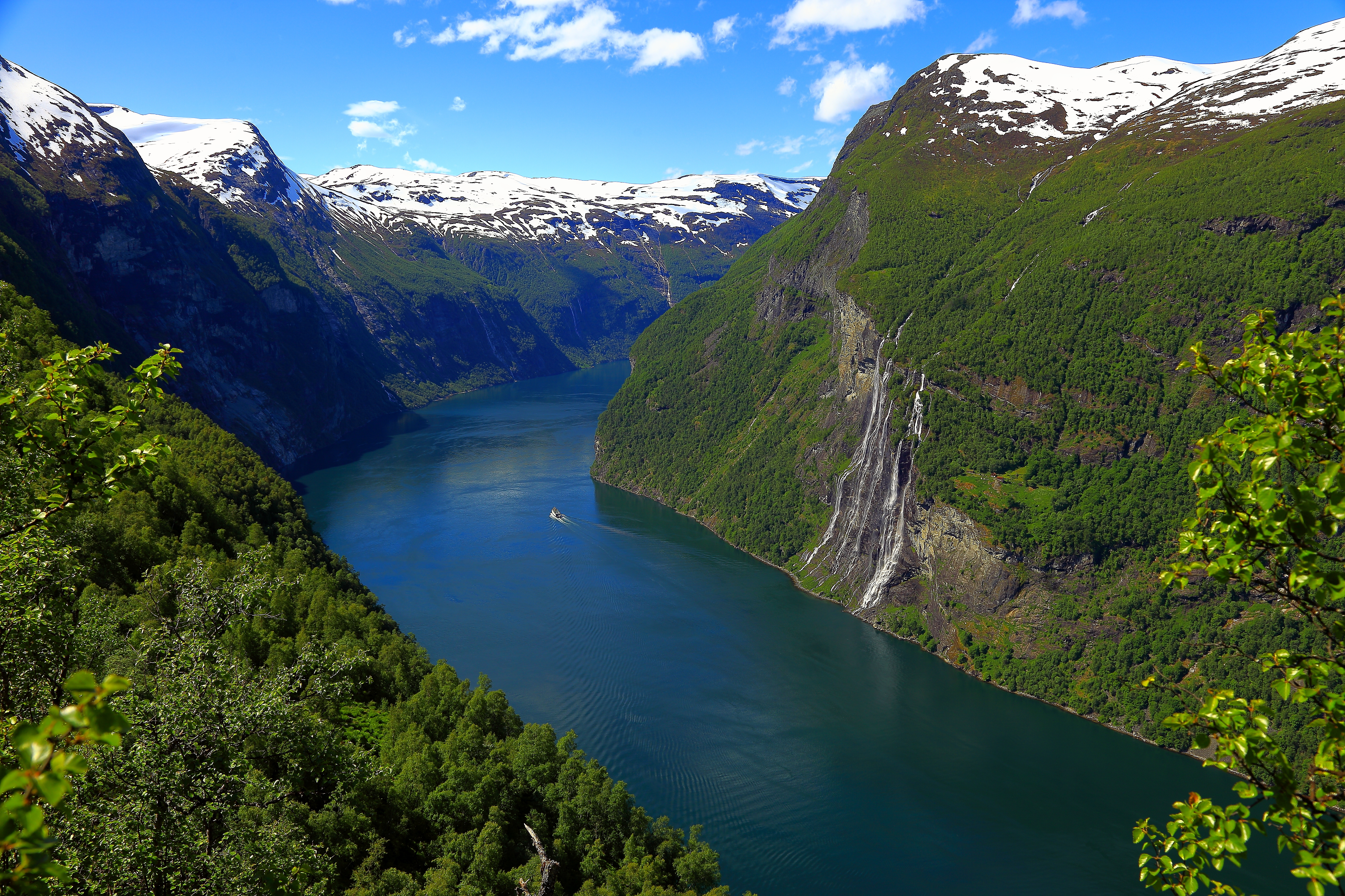 Fjord in Norway with snow capped mountains on each side