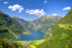 Geirangerfjord with pastures, mountains and tree-clad slopes