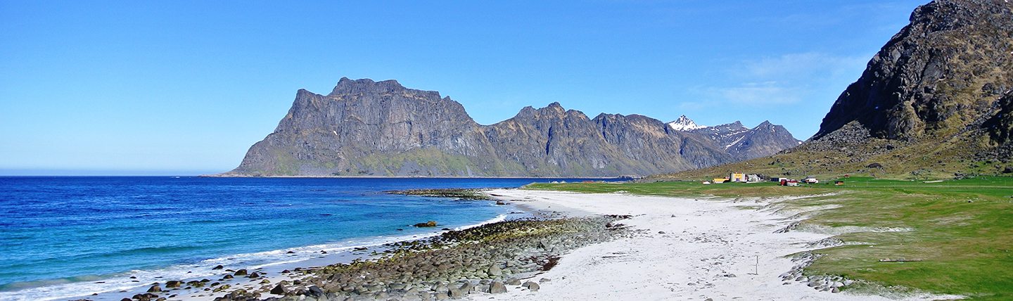 Deserted sandy beach with mountains Lofoten islands