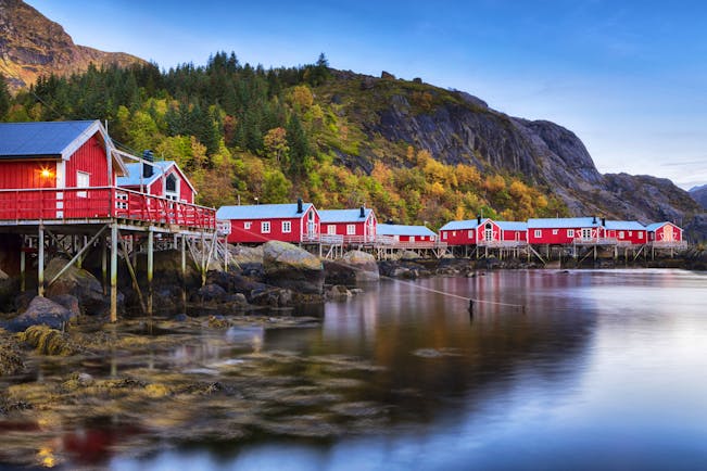 Red wooden houses on stilts over water at Nusfjord Lofoten