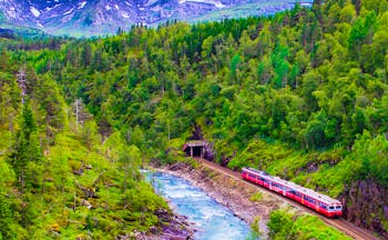 Red train in mountains from Oslo to Bergen