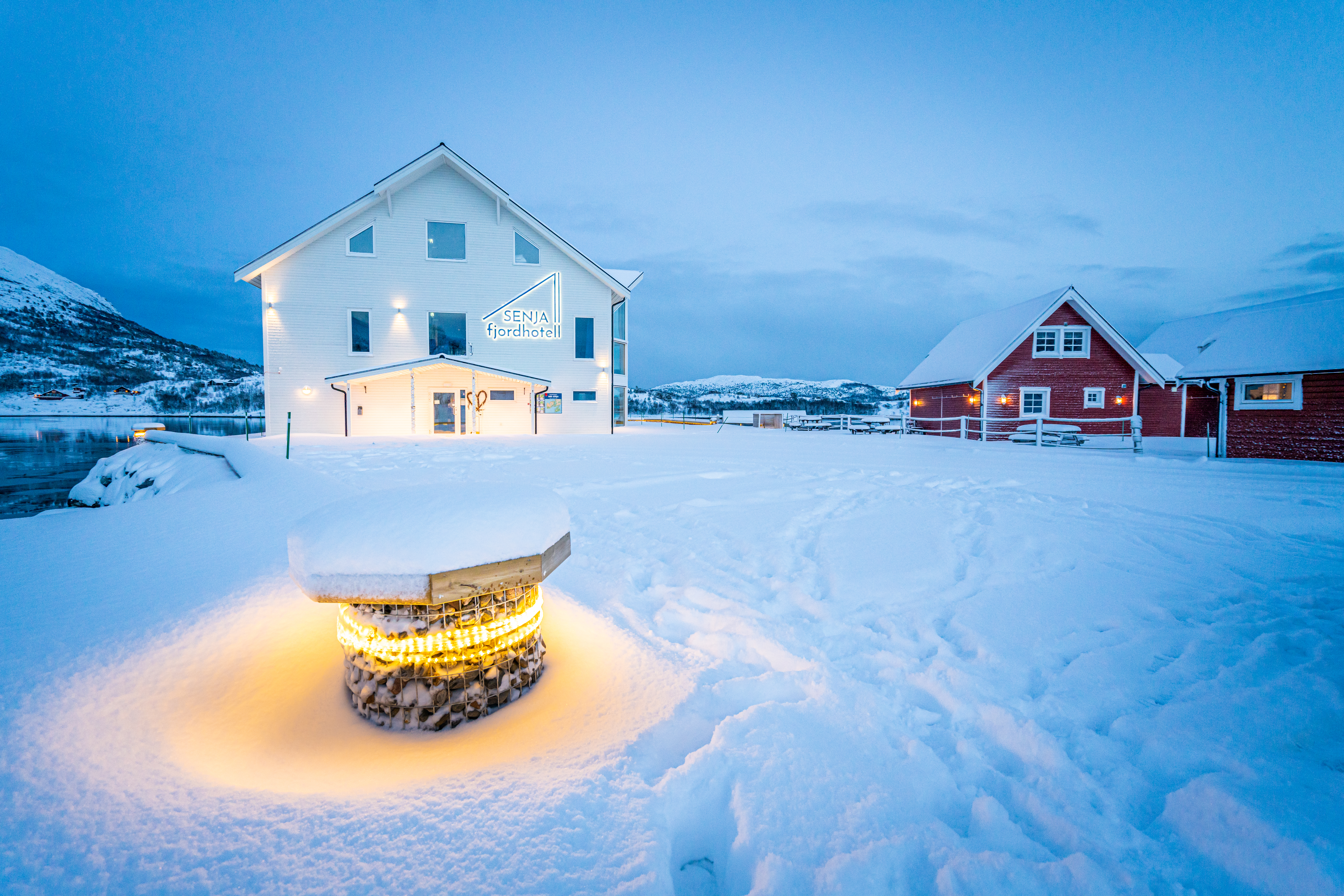 Senja Fjordhotell white and red houses in snow