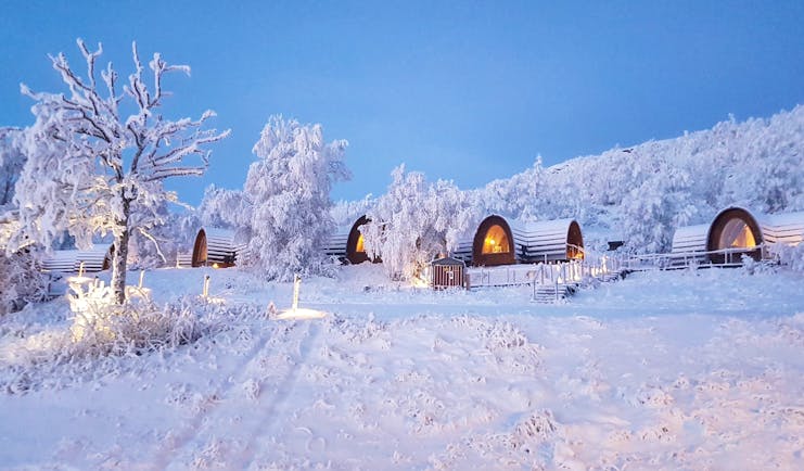 Snowhotel Kirkenes wooden cabins in the snow