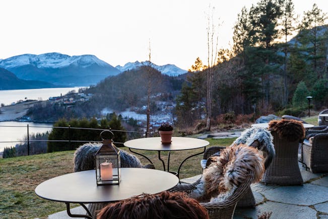 Storfjord Hotel garden with chairs and fur rugs