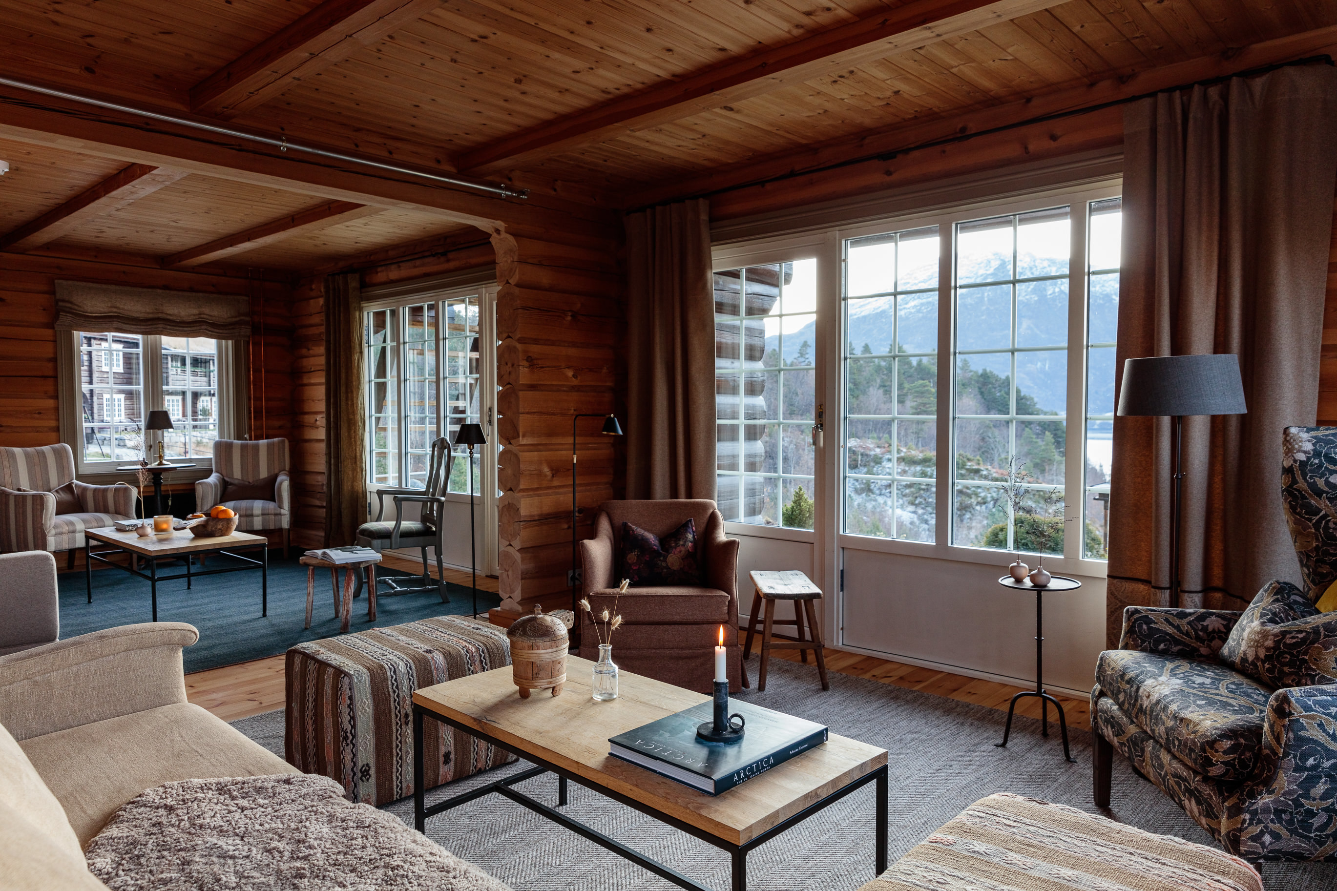 Storfjord Hotel lounge with sofas and chairs and views of lake