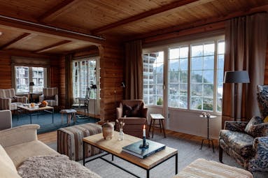 Storfjord Hotel lounge with sofas and chairs and views of lake