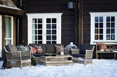 Storfjord Hotel patio with snow on ground and seating