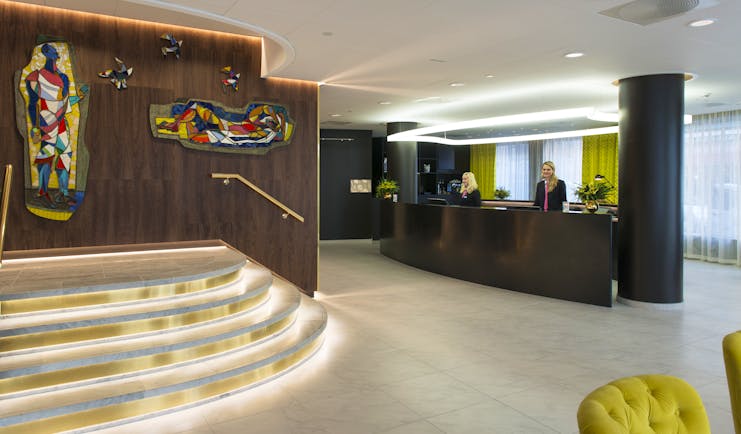 Wooden reception desk and stairs at Thon Hotel Rosenkrantz Oslo