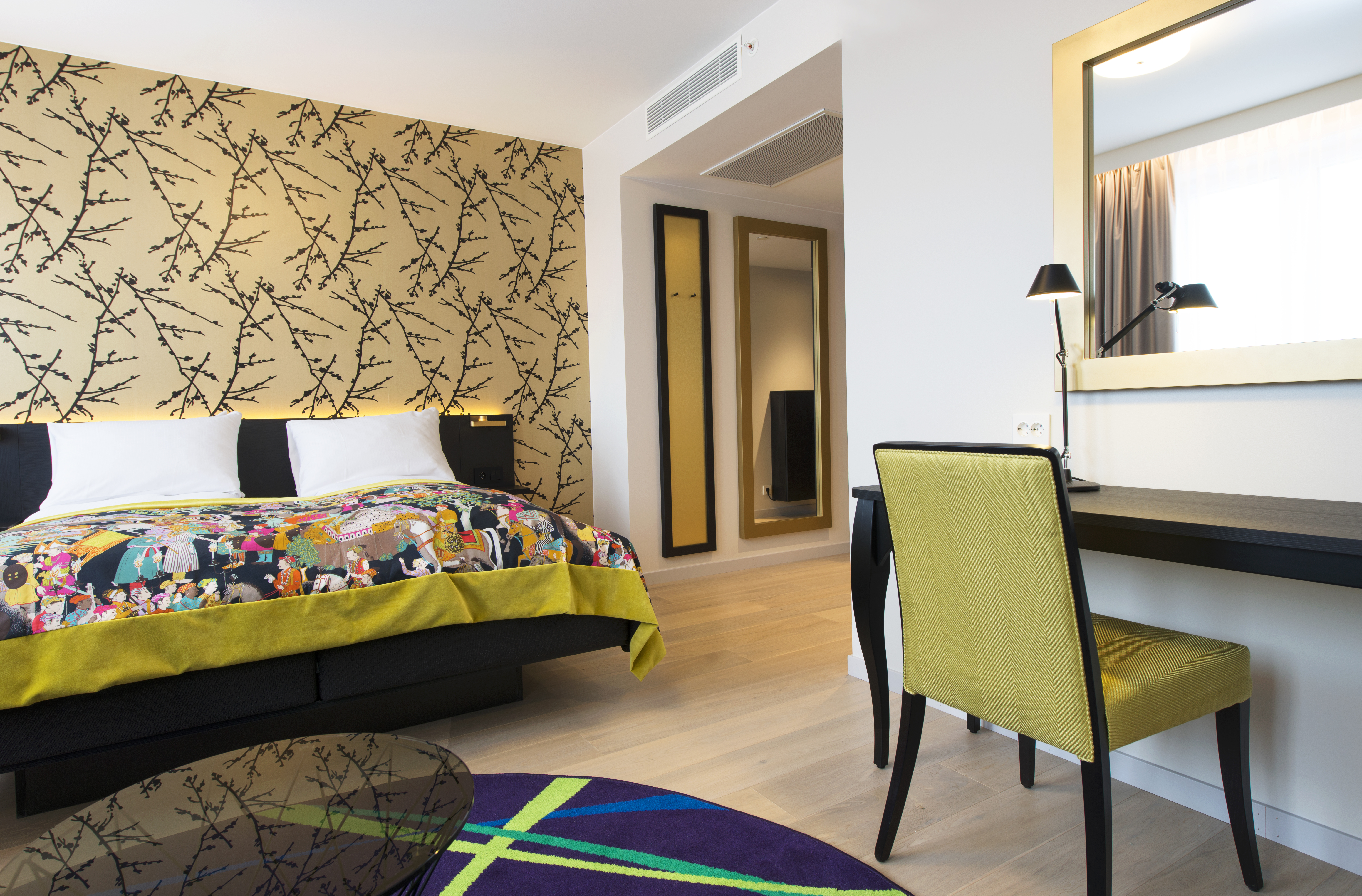 Rooom with wooden floor and colourful bedspread Thon Hotel Rosenkrantz Oslo