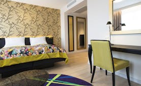 Rooom with wooden floor and colourful bedspread Thon Hotel Rosenkrantz Oslo